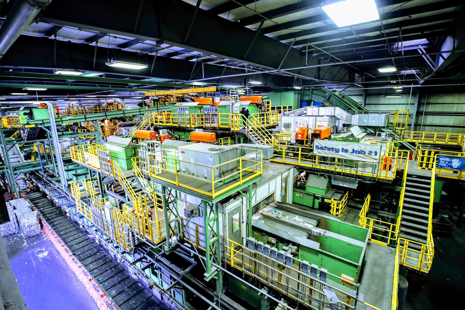 Industrial material recovery facility with conveyors and sorting equipment
