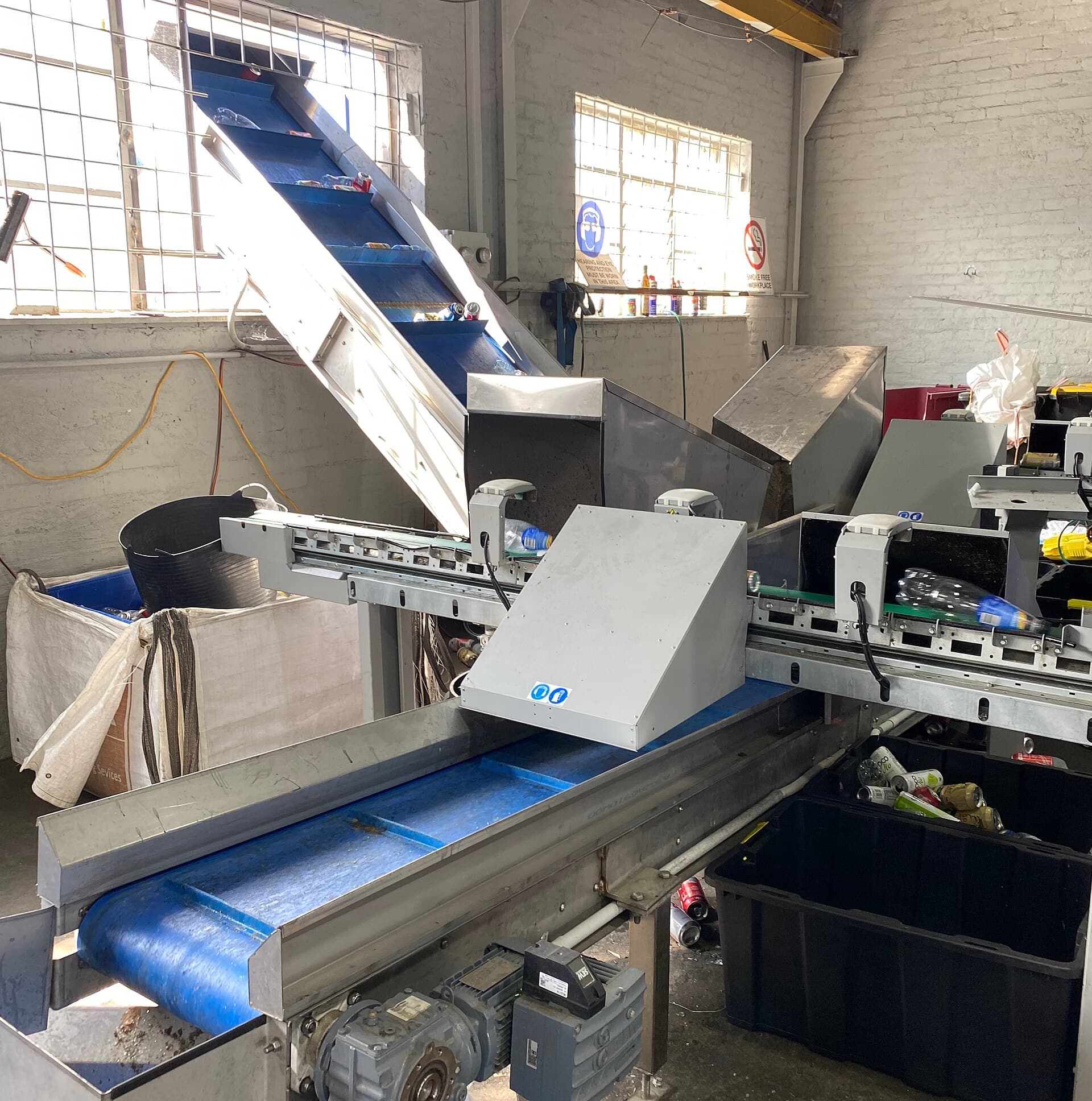 Conveyor belts sorting bottles and containers at a recycling facility